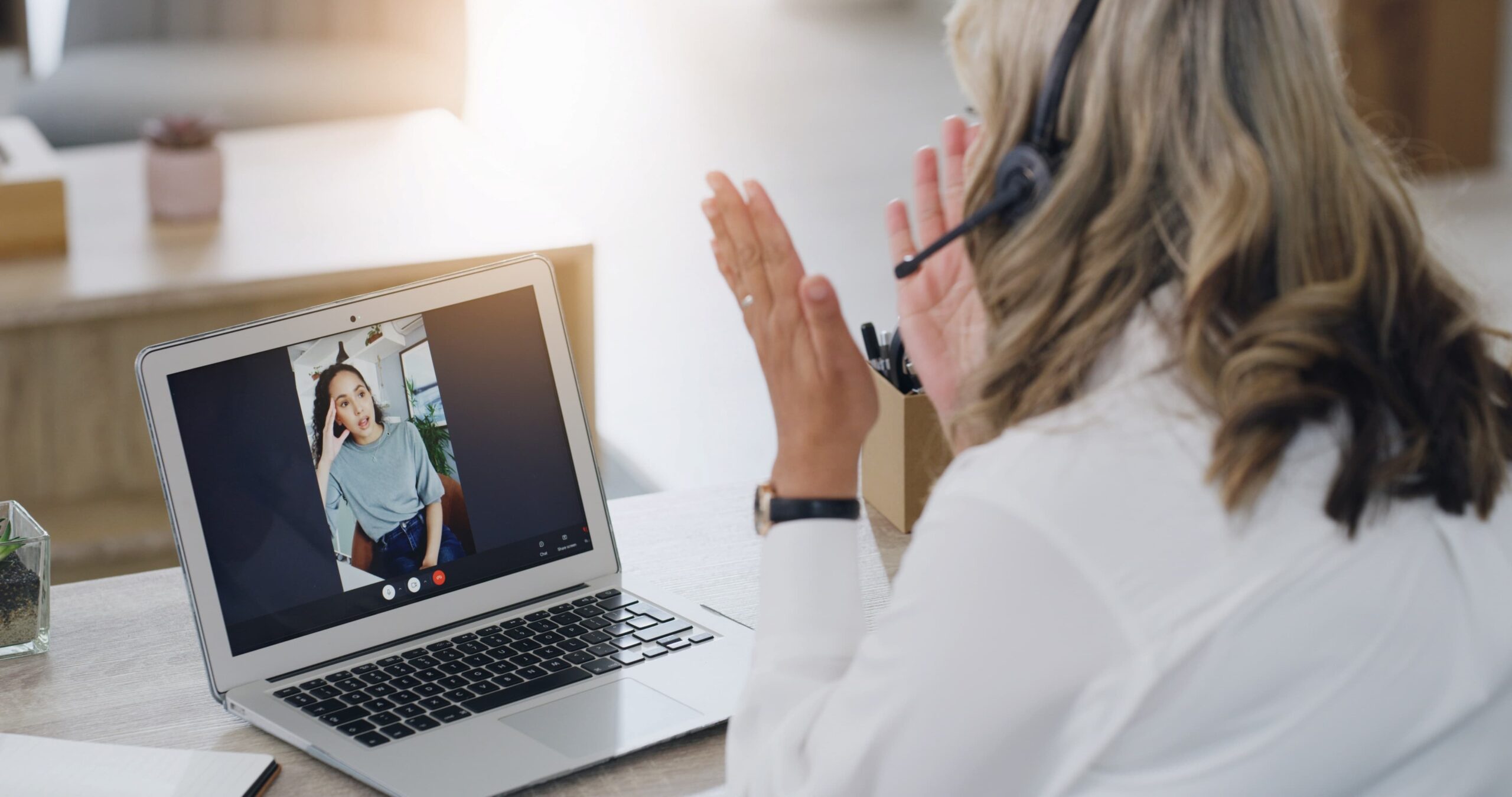 Therapist speaking with a client through a video session